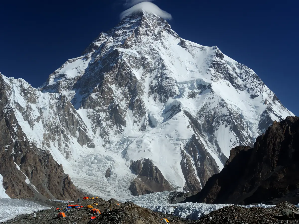 The pyramid of K2 rising above the glacier under a clear high-altitude sky