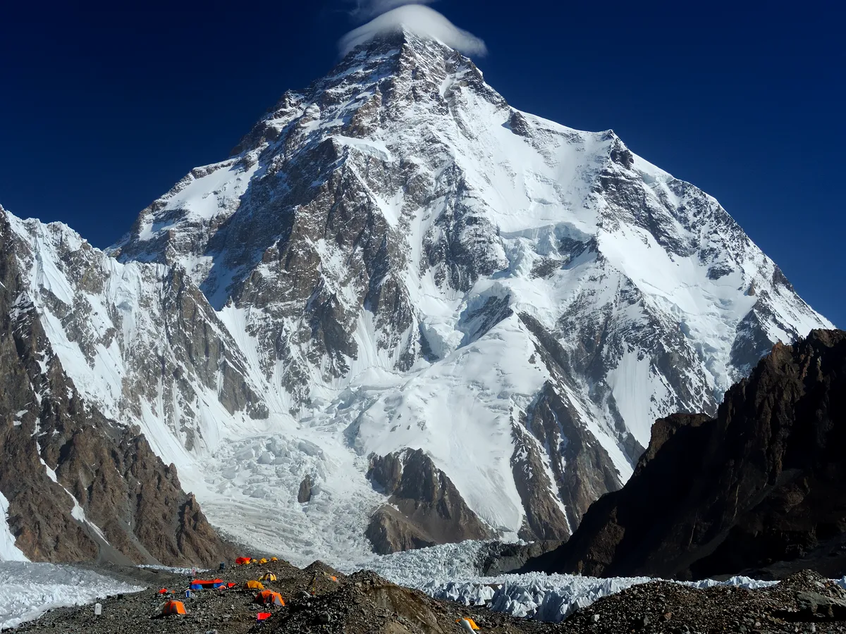 The pyramid of K2 rising above the glacier under a clear high-altitude sky