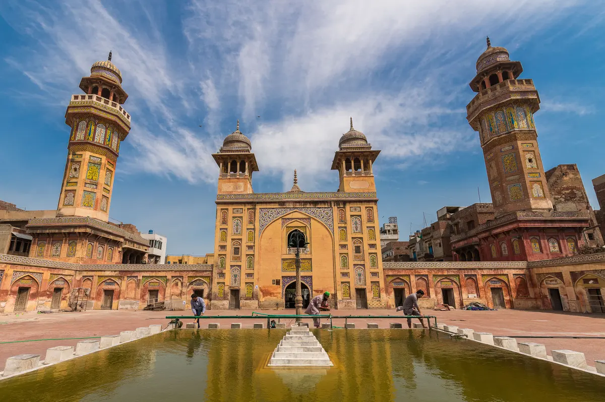 The tiled façade and courtyard of Wazir Khan Mosque in Lahore's Walled City